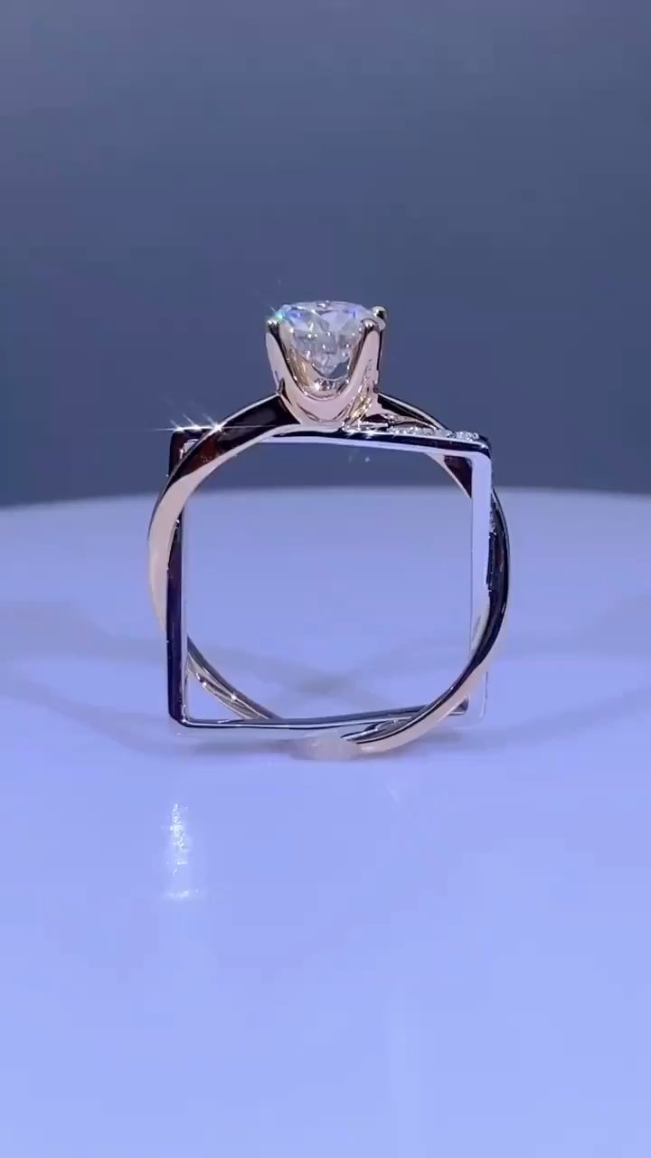 a white diamond ring sitting on top of a table