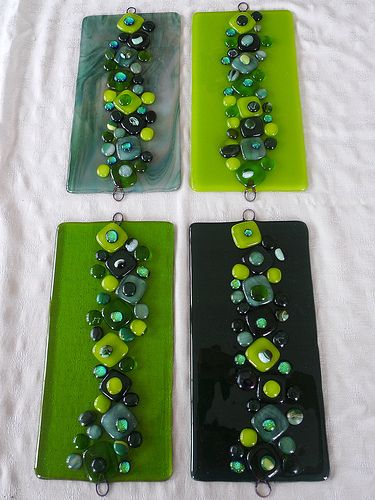 four pieces of glass with green and black beads