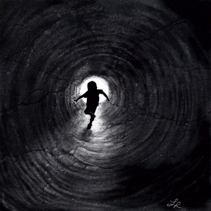 the silhouette of a person in a dark tunnel