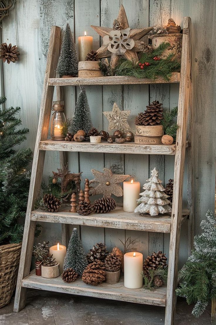 an old ladder is decorated with pine cones, candles and other christmas decorations for display