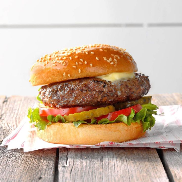 a hamburger sitting on top of a wooden table