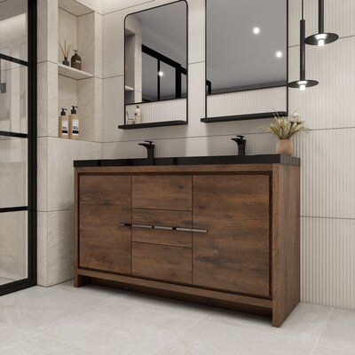 a bathroom with two sinks and mirrors on the wall