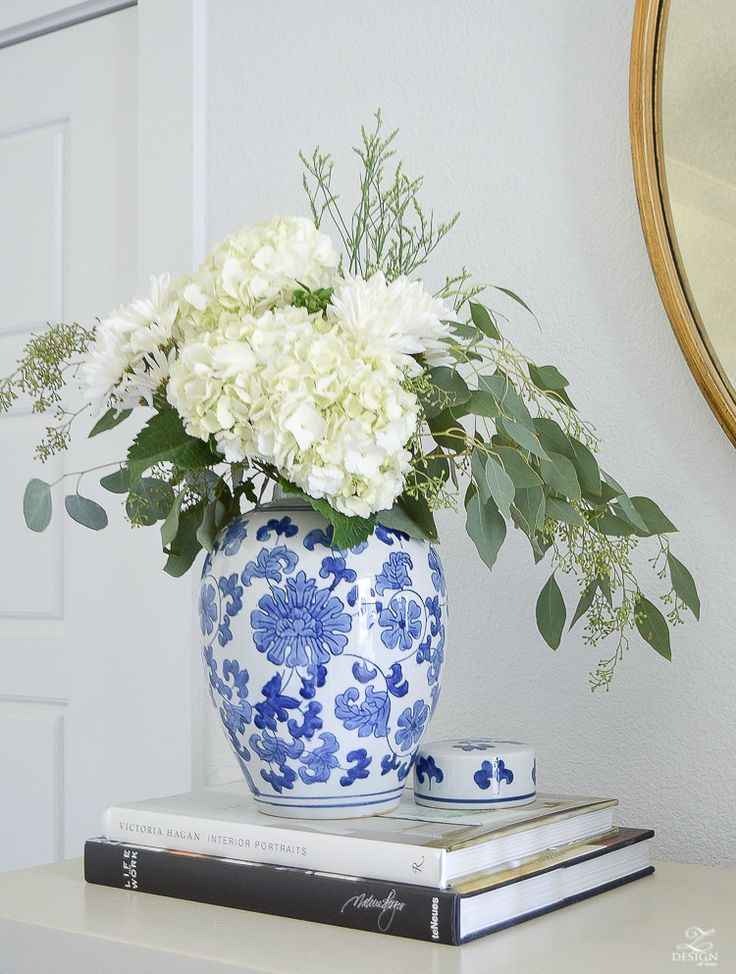 a vase filled with white flowers sitting on top of a table