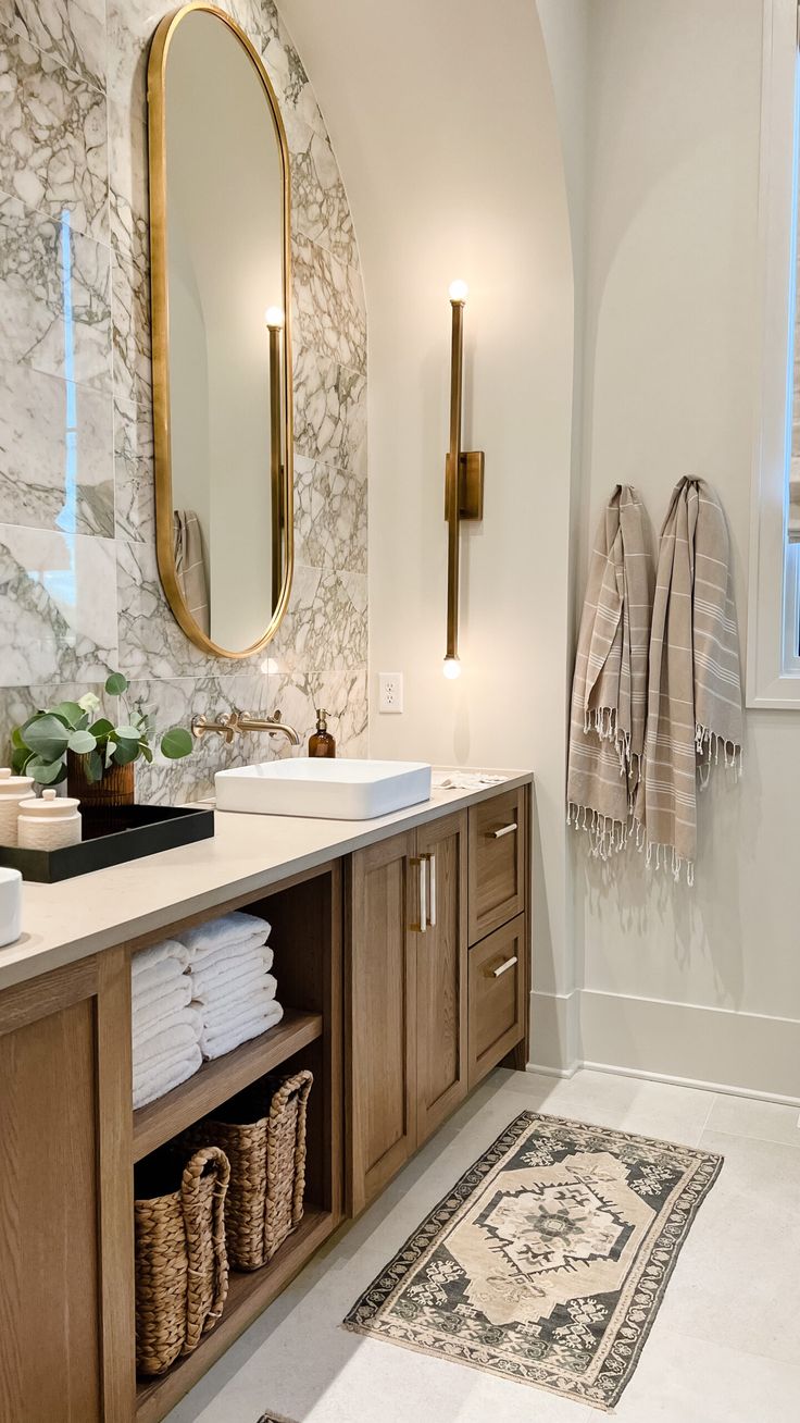 a bathroom with marble walls and wooden cabinets