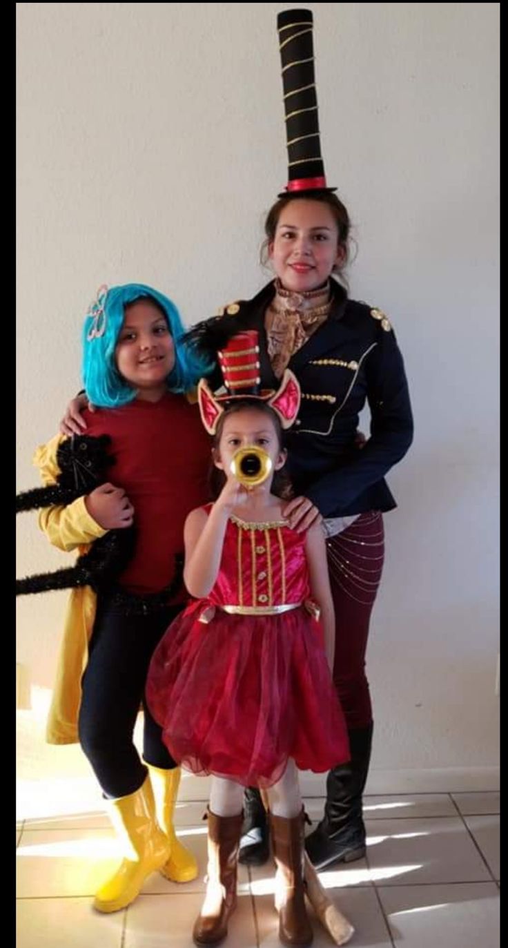 three children dressed in costumes posing for the camera