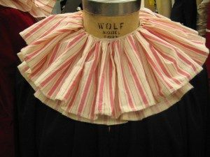 a mannequin wearing a pink and white striped dress with ruffles on it