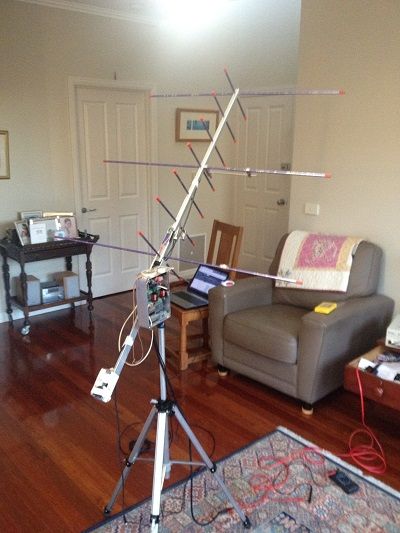 a camera set up on a tripod in a living room next to a couch