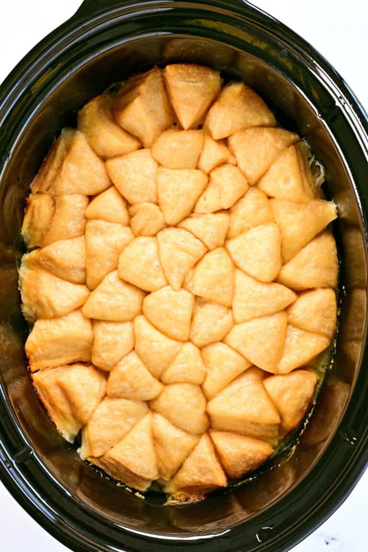 a crock pot filled with food sitting on top of a table