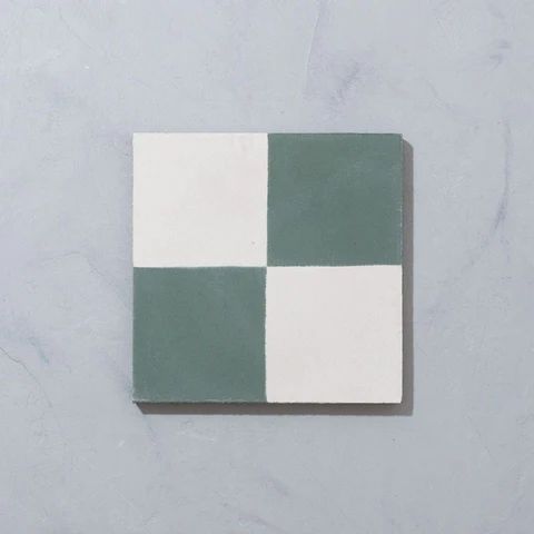 a white and green tile on the wall