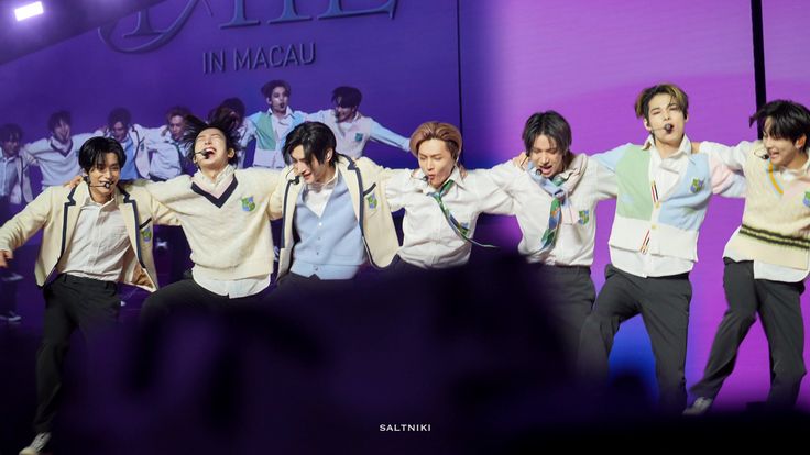 a group of young men standing on top of a stage