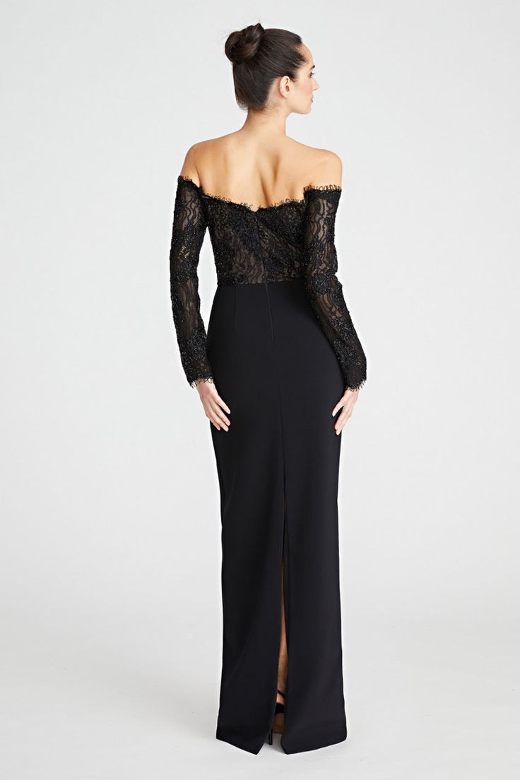 a woman in a long black dress with an off the shoulder lace top and slited skirt