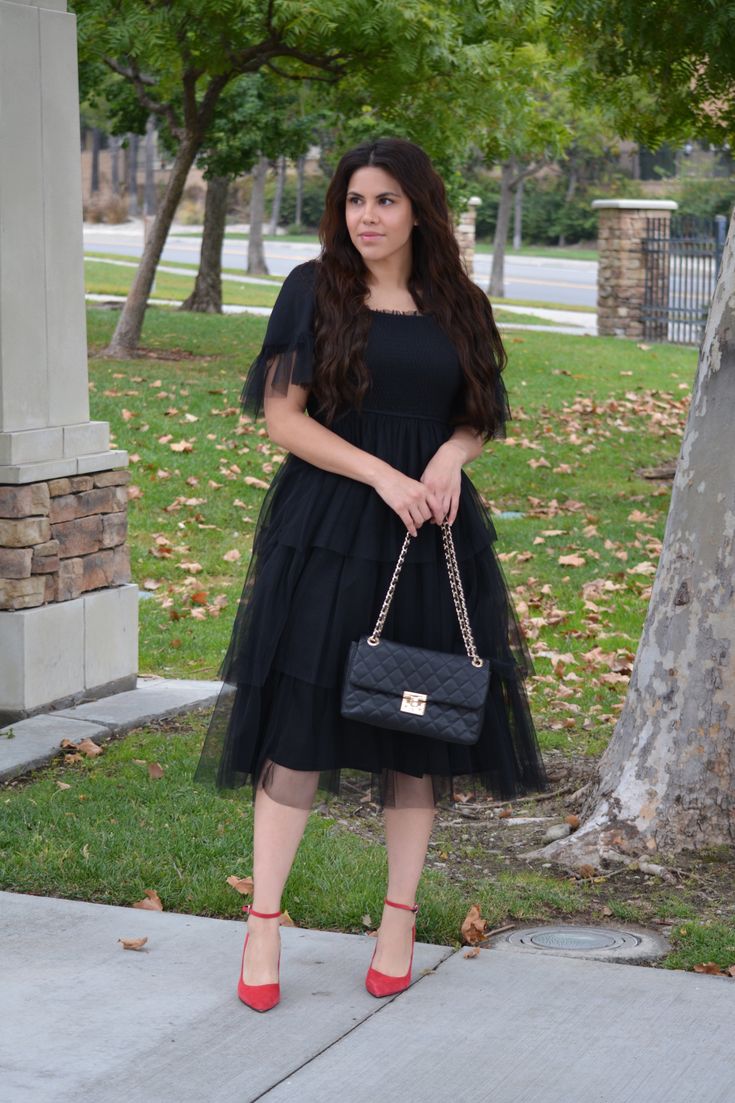 Perfect for the holidays! Black tulle Dress Fully lined Smocked stretchy bodice Square neckline (would look cute with a black layering shirt like our Rae) Modeled in large 5'7" 100% Polyester Small (bust 36"/waist 28-32"/length 46") Medium (bust 38"/waist 30-34"/length 46") Large (bust 40"/waist 32-36"/length 46") XLarge (bust 42"/waist 34-38"/length 46") *To measure yourself: Bust - measure the widest part of your bust with your bra on. Waist - measure the most narrow part (usually bellybutton) Spring Black Mesh Dress With Tulle Skirt, Black Mesh Dress With Tulle Skirt For Spring, Black Midi Dress With Tulle Skirt, Black Tulle Skirt Dress For Night Out, Chic Black Tulle Skirt Dress, Black Tulle Dress For Night Out, Fall Party Tulle Dress, Spring Black Tulle Mesh Dress, Spring Black Mesh Dress