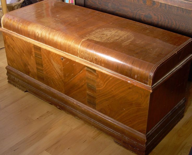 a large wooden chest sitting on top of a hard wood floor