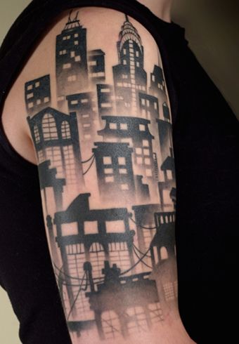 a woman with a black and white city tattoo on her arm is looking at the camera