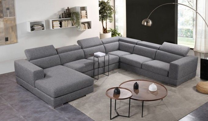 a living room with a sectional couch and coffee table