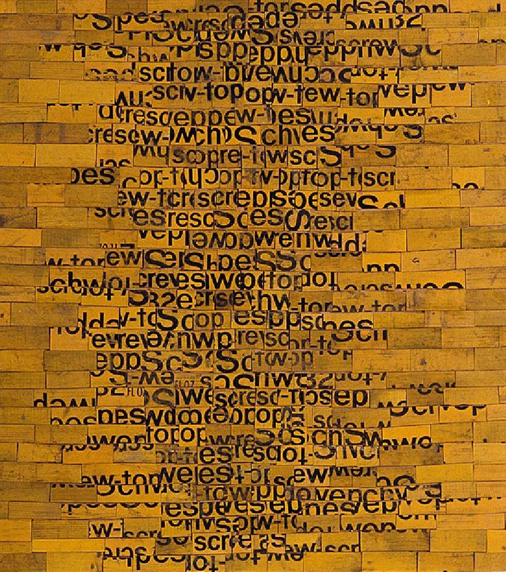 a piece of wood with words written in black and yellow on the bottom half of it