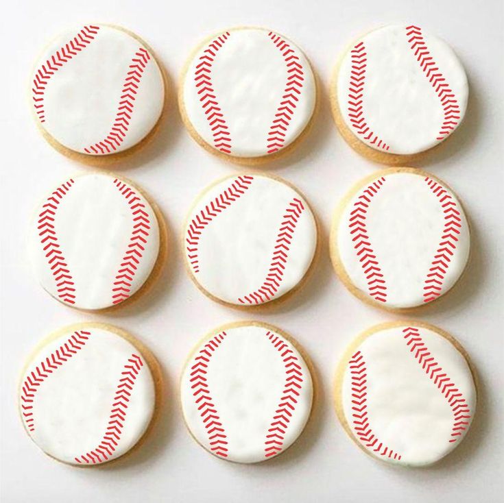 baseball cookies decorated with white icing and red stripes