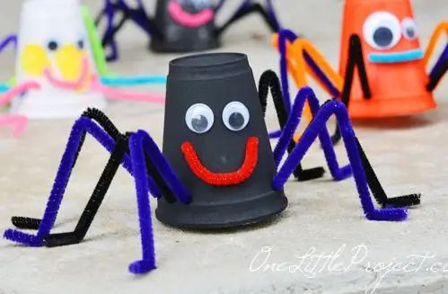 these paper cups are made to look like spiders with googly eyes and legs