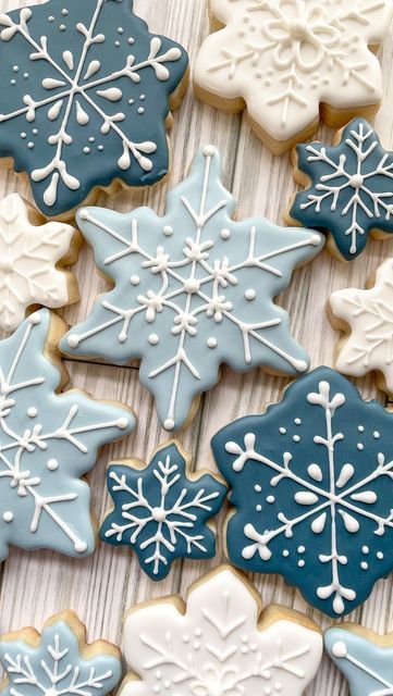 snowflake cookies are arranged on a table