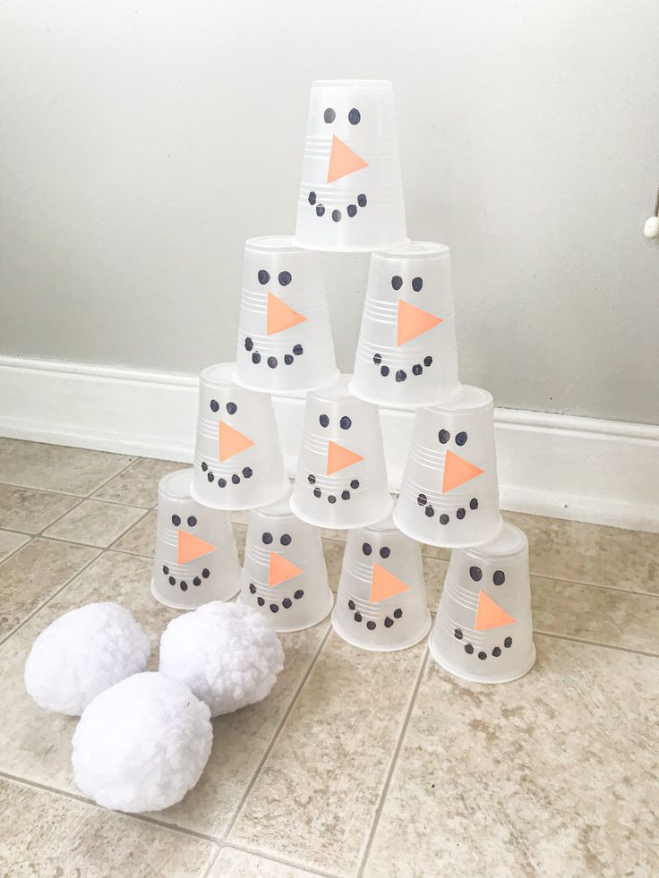 snowmen made out of cups sitting on the floor