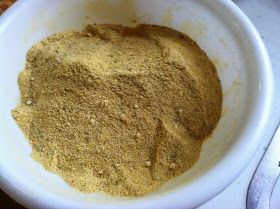 a white bowl filled with brown powder on top of a table