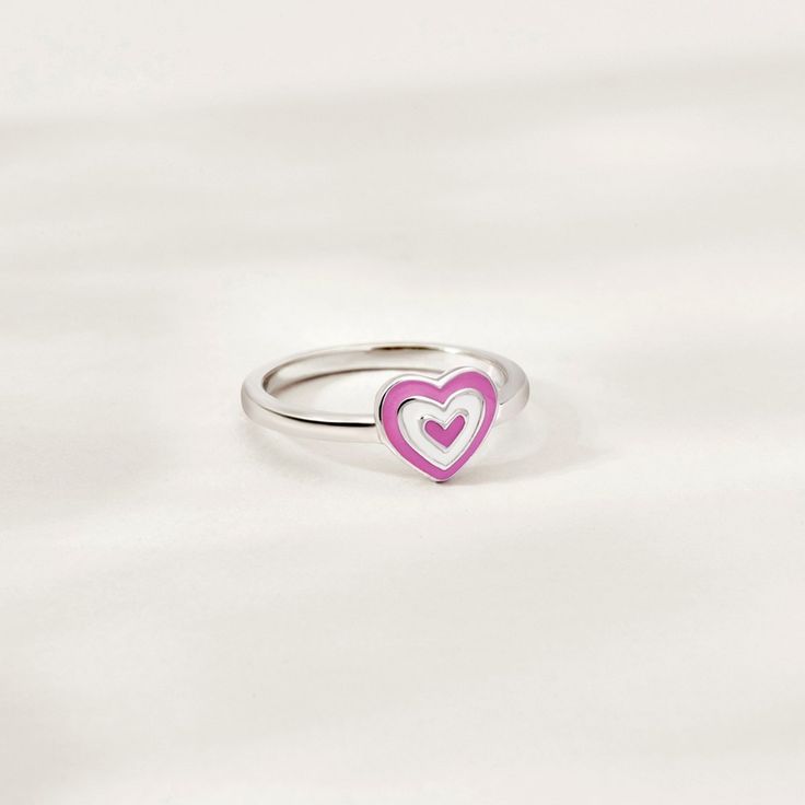 This groovy heart ring is such a sweet accessory for any child who loves fun and fashion. The cute pink and white enamel design adds a touch of playfulness, making it a favorite among young girls. Made from high-quality 925 sterling silver, it is both durable and hypoallergenic, ensuring that it is safe for even the most sensitive skin. The heart-shaped design is not only adorable but also a symbol of love and affection, making it a meaningful gift for any special occasion. This adorable ring is Trendy Silver Heart Ring For Valentine's Day, Trendy White Enamel Rings, Adjustable Pink Personalized Rings, Pink Heart-shaped Jewelry For Friendship, Pink Enamel Ring For Valentine's Day Gift, Personalized Pink Heart Ring, Personalized Pink Ring For Birthday, Nickel Free Pink Promise Ring, Trendy Adjustable Heart-shaped Rings