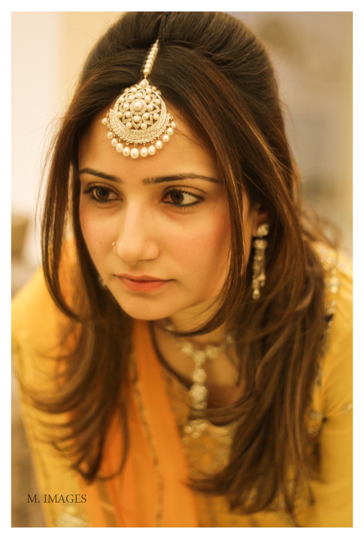 a woman with long hair wearing a head piece