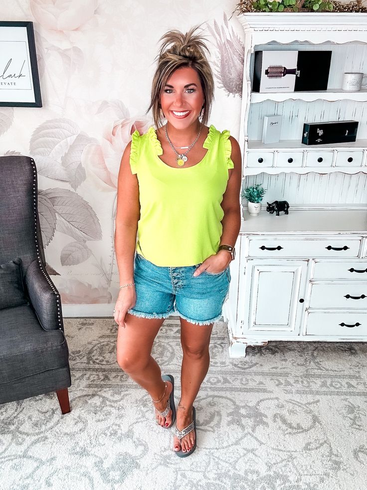 This flirty scoop neck tank is out to give your wardrobe a thrill. With its ruffle trim and relaxed, breezy fit, this top was made for turning heads on steamy summer nights. The soft, lightweight material will keep you cool while the slim straps show off your sun-kissed shoulders. Whether you're meeting your crew for margaritas or embarking on a beachside date, this little number adds a playful pop of romance to any look. After a long winter, you deserve to bare your arms in style. Slip into thi Flirty Tank Top For Spring, Flirty Spring Tank Top, Flirty Tank Top With Ruffled Straps For Day Out, Flirty Ruffled Straps Tank Top For Day Out, Flirty Tank Top For Spring Day Out, Flirty Spring Tank Top For Day Out, Flirty Ruffled Tank Top For Summer, Scoop Neck Ruffled Tops For Spring, Spring Ruffled Scoop Neck Top