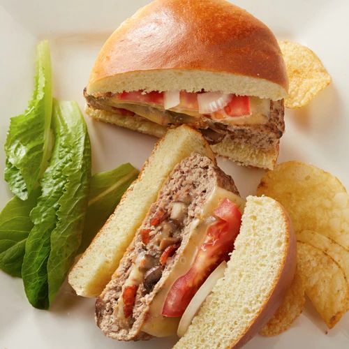 a close up of a sandwich and chips on a white plate with lettuce