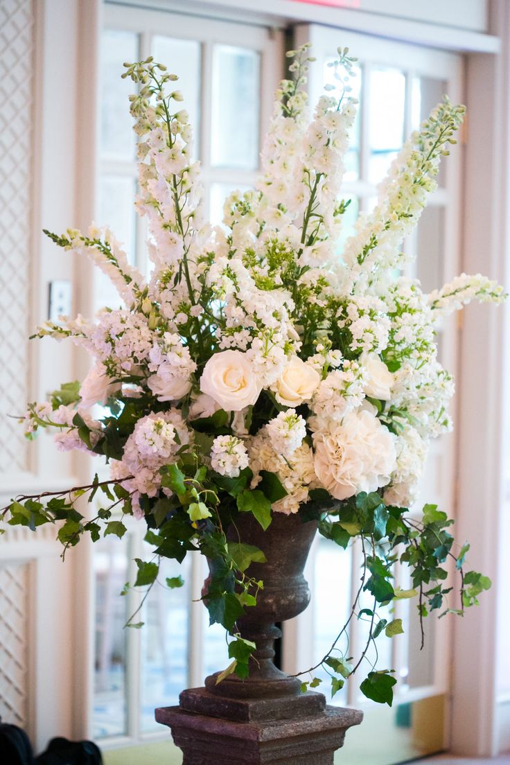 a vase filled with white flowers on top of a table