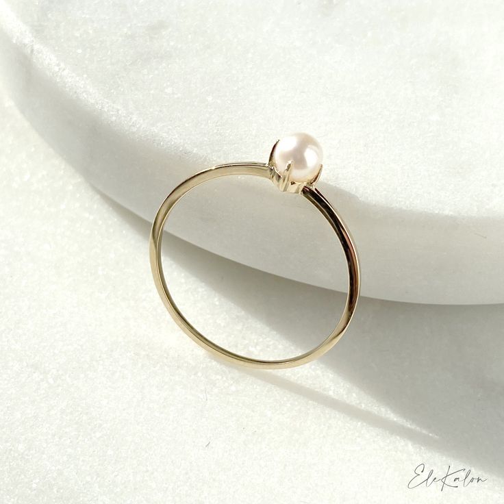 Elegant and timeless, mini Akoya pearl solitaire ring handcrafted in 10K solid yellow gold. Make it a treasure to yourself. Ships within 3 business days. - Stone info: 1pc of 3 to 3.5mm size mini genuine Akoya pearl - Band width: 1mm - The ring sits 4.45mm on the finger. - Made in 10 karat gold - Stamp with 10K. Modern Diamond Earrings, Pearl Promise Rings, Small Pearl Ring, Pearl Ring Simple, Ball Outfits, Wishbone Necklace Gold, Akoya Pearl Ring, Pearl Wedding Ring, Flower Wedding Ring