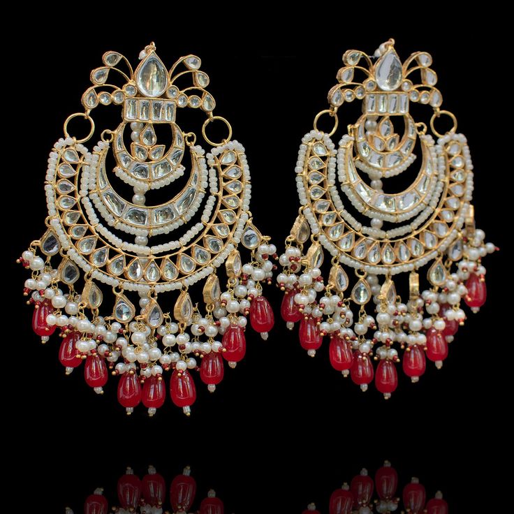 Whimsical symphony in this beautiful rendition of enchantment! This alluring ensemble is hand-rendered with embellishments, detailed with kundan stones and bloomed with moti and beads to sing a melody of luxury for a splendid look. The set includes a necklace and a pair of matching earrings. Approximate earrings length is 4.5". Gold-plated on a high-quality brass as base metal. Made by order. Kindly allow 5-7 weeks for the delivery of this item. For custom or urgent requests, please contact supp Kundan Anarkali Set For Reception And Festivals, Elegant Kundan Lehenga With Gota Work, Traditional Semi-stitched Anarkali Set With Stone Work, Embellished Anarkali Set For Reception And Festivals, Elegant Chandbalis With Cutdana For Designer Wear, Elegant Chandbalis With Stone Work For Designer Wear, Elegant Chandbalis For Festivals, Elegant Designer Chandbalis For Festivals, Festive Bollywood Anarkali Set With Intricate Design