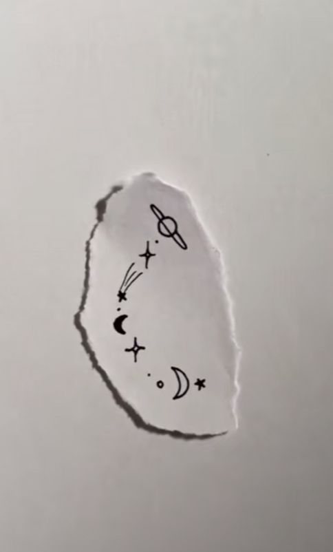 a piece of paper that has been drawn on with the moon and stars above it