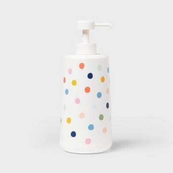 a white soap dispenser with multicolored dots