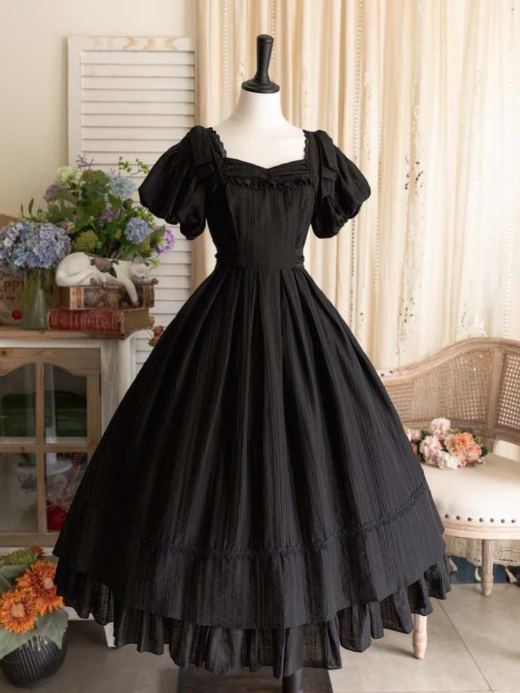 This price includes a dress and a black bowknot hairclip (not for sale).  Embrace timeless elegance with this enchanting Black Puff Sleeves Classic Lolita Princess Tea-Length Dress. Designed for the true Lolita aficionado, this dress features delicately puffed sleeves and a flattering tea-length skirt that exudes sophistication and charm. The back boasts a comfortable shirring detail, ensuring a perfect fit for all body types. Whether you're attending a tea party, a cosplay event, or simply indu Dark Tea Party Outfit, Vintage Bow Dress For Costume Party, Vintage Black Puff Sleeve Dress, Vintage Dresses 50s 1950s Fashion Classy, Halloween Costumes With A Black Dress, Black Dress For Halloween, Victorian Black Dress, Black Witchy Dress, Black Medieval Dress