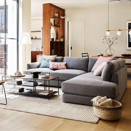 a living room filled with furniture and a large window