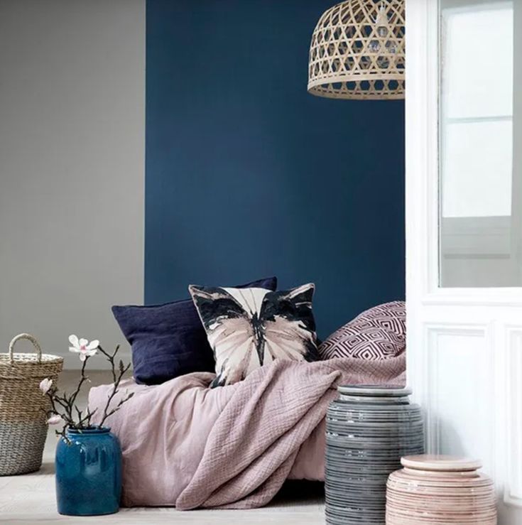 a bedroom with blue walls and white trim on the wall, along with various decorative items