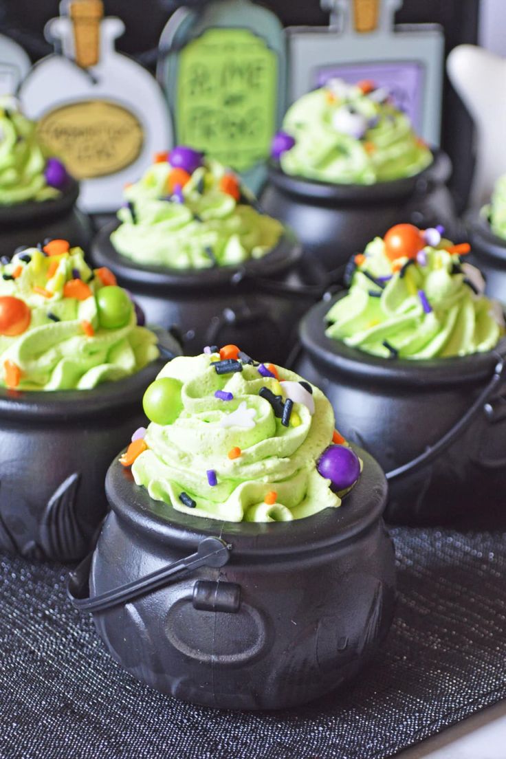 halloween cupcakes with green frosting and sprinkles in witches hats