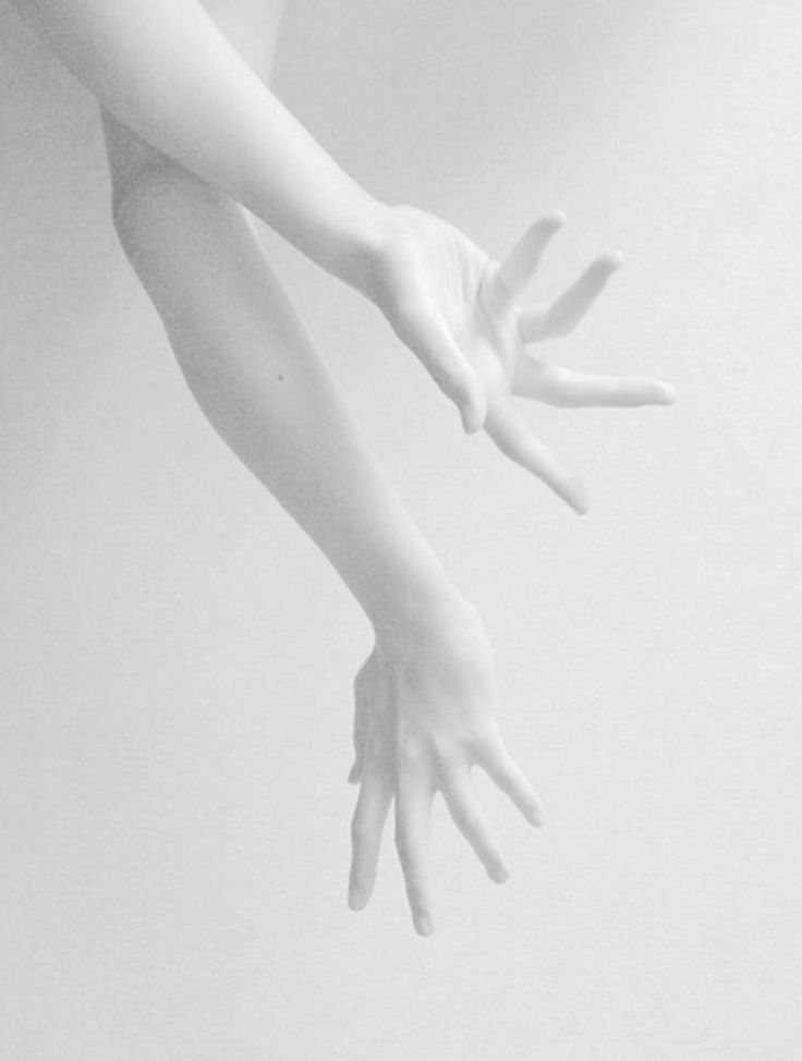 a woman's hands reaching up into the air