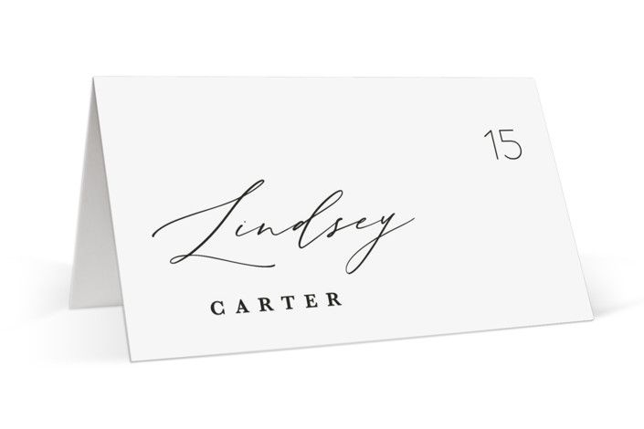 a table number card with the name and date printed on it's front side