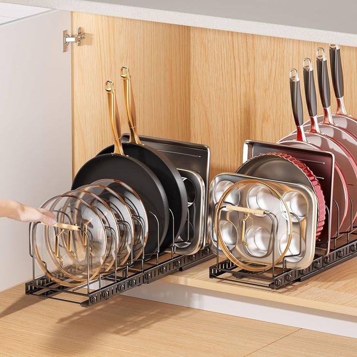 there is a rack with many dishes in it and someone reaching for the dishwasher