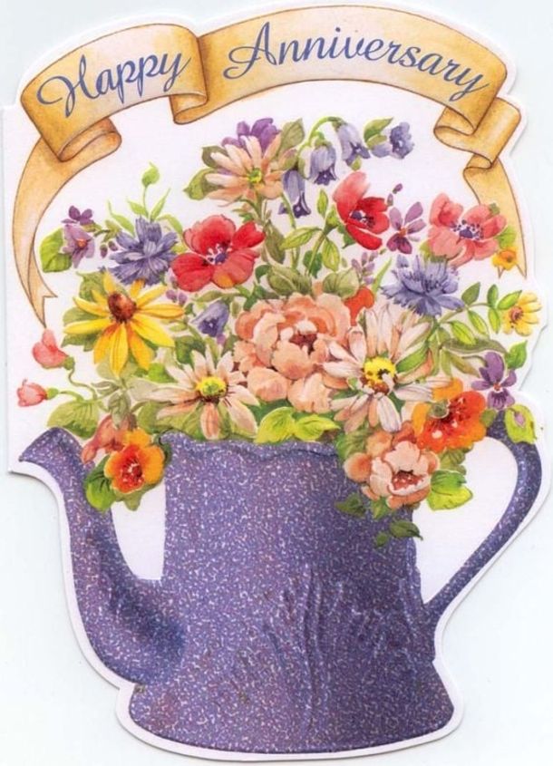 an image of a happy anniversary card with flowers in a watering can and ribbon around it