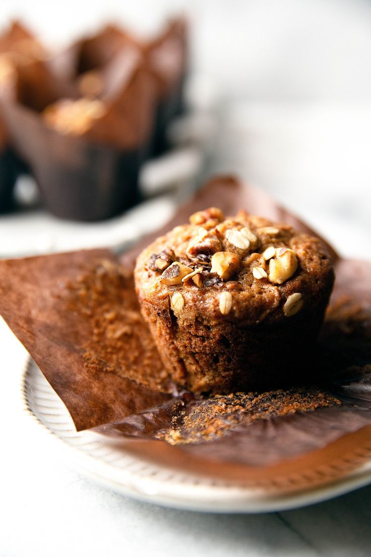 two muffins sitting on top of a white plate