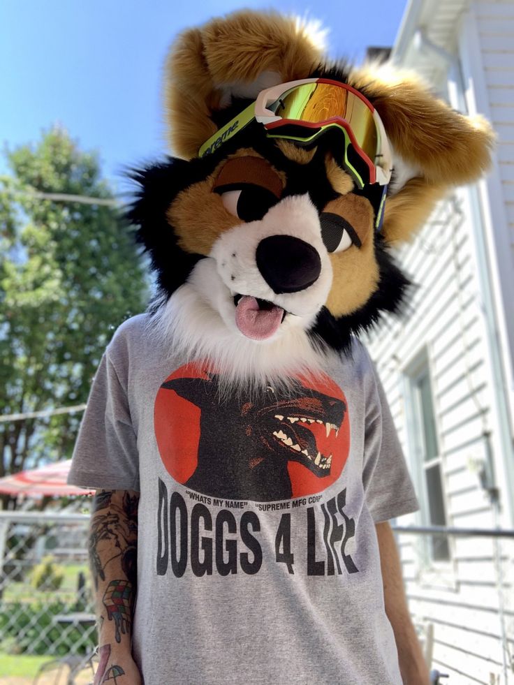 a man wearing a t - shirt with a dog mask on his head