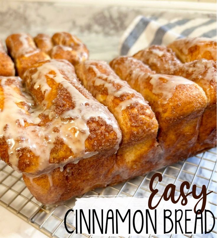 cinnamon bread on a cooling rack with icing drizzled over it and the words easy cinnamon bread