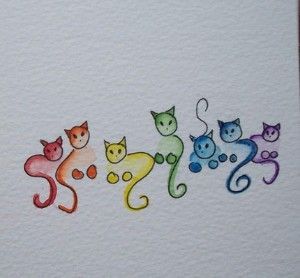 some colorful cats are sitting in the shape of letters that spell out what's inside