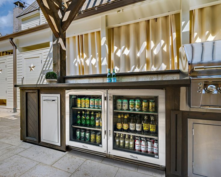 an outdoor bar with coolers and drinks on display in front of the door that says weekend ready