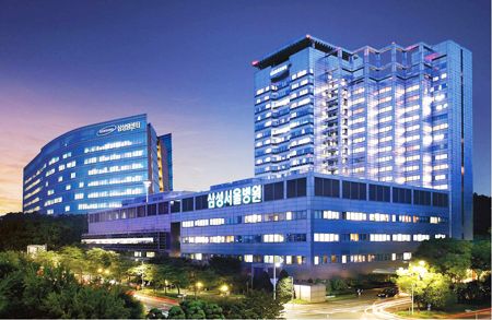 an office building lit up at night in the city