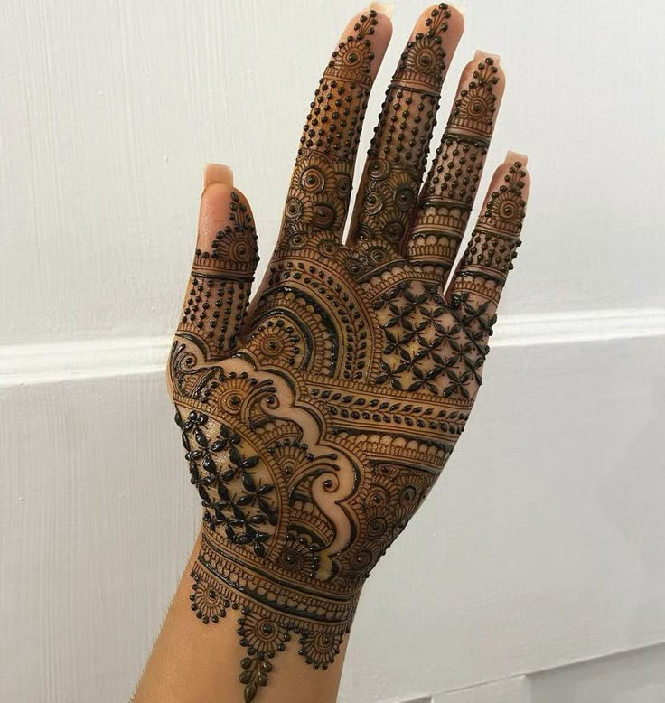 a hand with henna tattoos on it