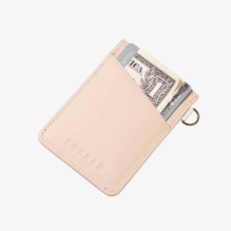 Meet the slim and secure Thread® Vertical Wallet. The outer pockets are made from our signature leather and tight-knit elastic, while the inner pocket features RFID blocking technology to protect your credit card information. Details • Holds 2-8 cards/cash • RFID secure pocket • Leather • Built in metal D-ring to attach lanyard, key hook, etc. • Elastic contains latexLength: 3.7 in (9.3 cm) Width: 2.7 in (6.9 cm) Thread Wallets, Tote Bag Organizer, Keychain Clip, Slim Leather Wallet, Wrist Lanyard, Lip Balm Holder, Utility Tote, Key Hook, Pouch Organizer